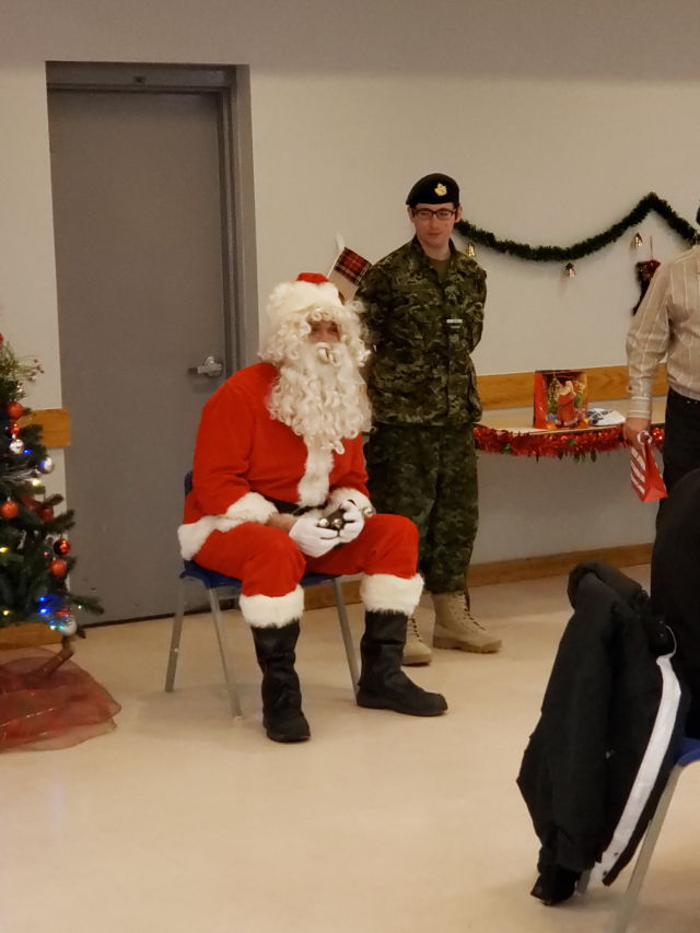 SANTA IS A BIG SUPPORTER OF OUR ARMED FORCES SO THEY ALWAYS PROVIDE HIM WITH A CADET TO MAKE SURE HE IS SAFE